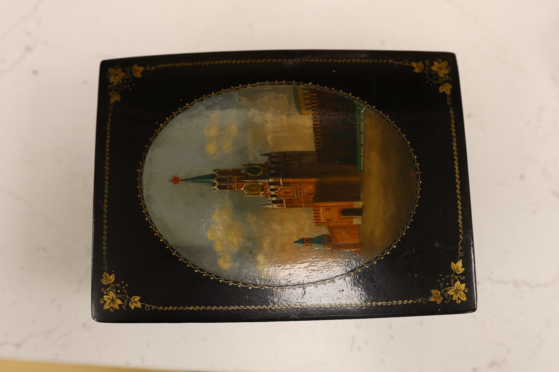 A Russian lacquer box, probably Fedoskino, 11.5cm wide x 15.5cm deep x 5cm high. Condition - some damage one side, fine overall marks